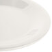 A close-up of a white Carlisle melamine pie plate with a wide rim.