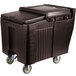 A large brown plastic Cambro mobile ice bin with wheels and a sliding lid.