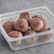 A plastic container filled with loose red beets.