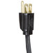 A close-up of a black electrical device with a black power cord and two gold plugs.