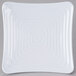 A white square Milano melamine plate with a spiral pattern.