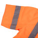 A close-up of a Cordova orange safety vest with reflective stripes.