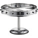A round stainless steel pedestal with black knobs holding order tickets.