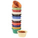 A stack of ivory melamine ramekins filled with food.