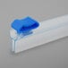 A clear plastic tube with a blue plastic safety slide cutter on the end.