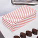 A 1/2 lb. Valentine's Day heart candy box with red hearts on it.