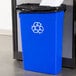 A blue Continental rectangular wall hugger recycle bin with a recycle symbol on it.