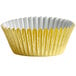 A yellow cupcake wrapper with a white and gold design.