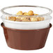 A bowl of nuts in a white fluted ramekin.