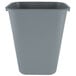 A Rubbermaid grey rectangular plastic wastebasket.