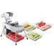 An Edlund electric vegetable slicer with two 3/8" blade assemblies slicing vegetables.