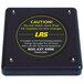 A black square LRS transmitter with yellow text reading "Caution" on it.