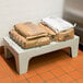 Cambro S-Series dunnage rack with bags of salt on a table.