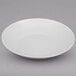 A Oneida Botticelli deep plate with a curved surface and thin rim on a white background.