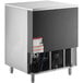 A stainless steel Manitowoc undercounter ice machine with a large metal bin.