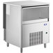 A stainless steel rectangular Manitowoc undercounter ice machine with a glass window.