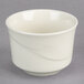 A close up of a Oneida cream white china bowl with a wavy design.