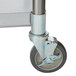 An APW Wyott stainless steel equipment stand with wheels.