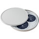 A round white stainless steel cooling plate with two round stainless steel containers inside.