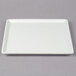 A white square Frilich display plate on a gray surface.