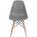 A gray Flash Furniture Elon plastic chair with wood legs.
