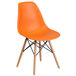 An orange Flash Furniture plastic chair with wooden legs.
