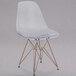 A Flash Furniture clear plastic chair with gold metal legs.