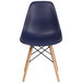 A navy plastic chair with wood legs.
