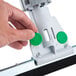 A hand holding a Unger SmartFit WaterWand with a green and white button.