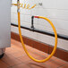 A yellow Regency gas connector hose attached to a pipe.