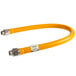 A yellow hose with silver metal connectors.