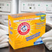 A box of Arm & Hammer Clean Burst HE Powder Laundry Detergent on a counter.