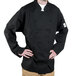 A man wearing a black Chef Revival long sleeve chef coat.
