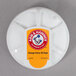 An Arm & Hammer Fridge Fresh refrigerator air filter in white packaging with a round label.