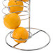A Tablecraft chrome spiral fruit basket with oranges on a metal rack.