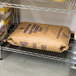A brown bag of Morton Coarse Kosher Salt on a shelf with other bags of flour.