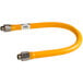 A yellow flexible hose with silver fittings.