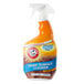 A bottle of Arm & Hammer hard surface cleaner on a counter.