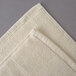 An Oxford Vicenza Avorio white bath mat with a folded edge.
