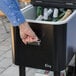 A hand opens a Choice black beverage cooler cart to reveal bottles of beer.