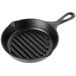 A Lodge black cast iron grill pan with a grate.