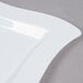 A white Fineline plastic square plate with a waved edge.