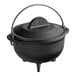 A Lodge black cast iron country kettle with a handle and cover.