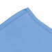 A close-up of a light blue fabric with a seam.