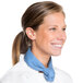 A woman wearing a white chef's coat and a light blue chef neckerchief.