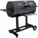 A black R & V Works Smokin' Cajun charcoal grill on wheels with a gauge.