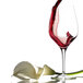 A Stolzle Chardonnay wine glass filled with red wine on a white background.