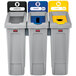 A white rectangular Rubbermaid Slim Jim recycling station with black and white labels for paper and bottles.