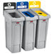 A Rubbermaid Slim Jim recycling station kit with open, paper, and bottle lids on three trash cans.