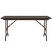 A walnut Correll folding table with an adjustable height and a melamine top.